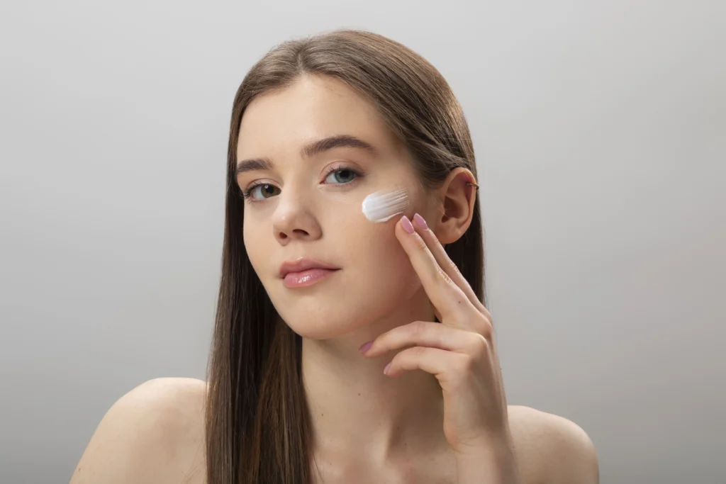 woman applying face cream front view (1)